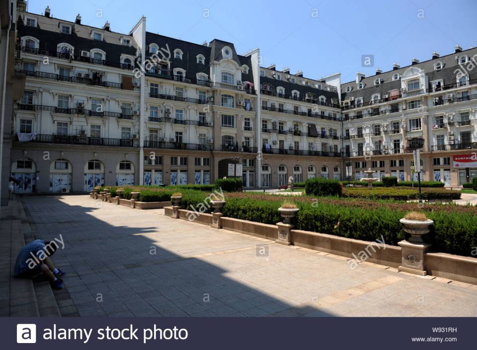 a-chinese-man-rests-in-the-shade-of-parisian-style-architectures-at-tianducheng-.jpg