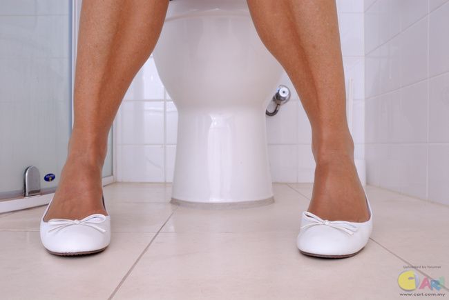 Woman-using-toilet.jpg