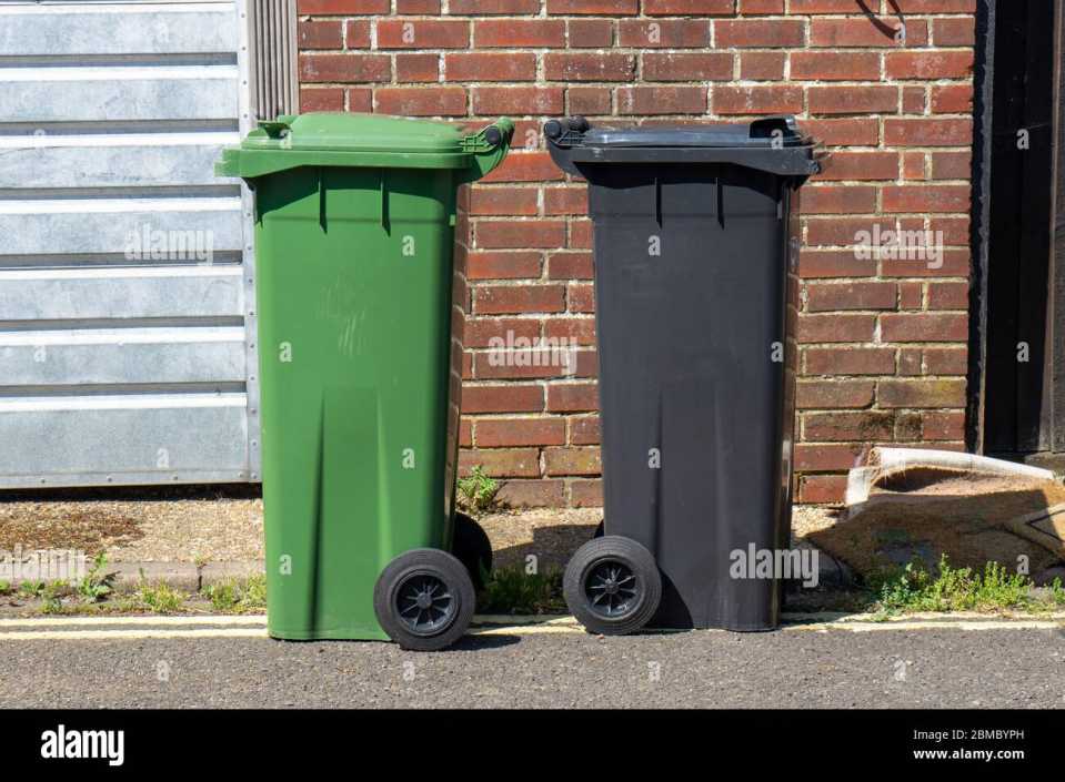 a-green-and-a-black-wheelie-bin-side-by-side-on-a-street-2BMBYPH.jpg