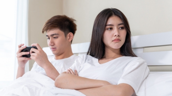 young-wife-sitting-bed-with-feeling-upset-her-husband-use-smartphone-napping-tim.jpg